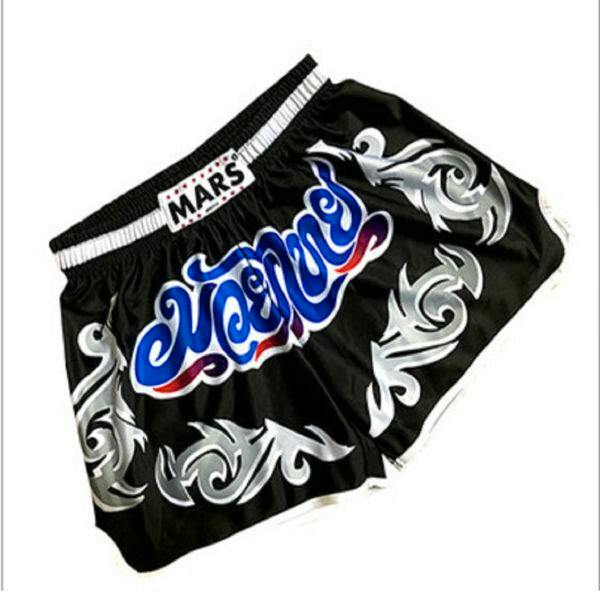Muay Thai kickboxing shorts (mens polyester) laid flat showing blue script center, silver tribal patterns, and an elastic waistband labeled 'MARS'.