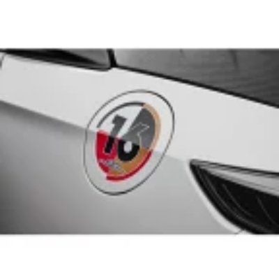 Circular '16' decal sticker applied to a car's exterior near the headlight.