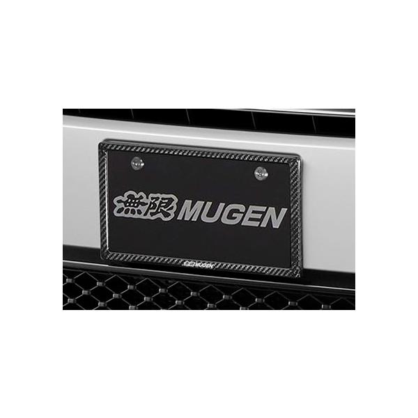 Front license plate garnish with MUGEN logo and carbon-fiber patterned border mounted on a vehicle bumper.