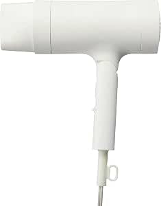 White MUJI negative ion hair dryer shown from the side with nozzle and attached power cord.