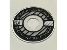Black ringless lever disk (joystick part) with white graphic pattern on a light background.