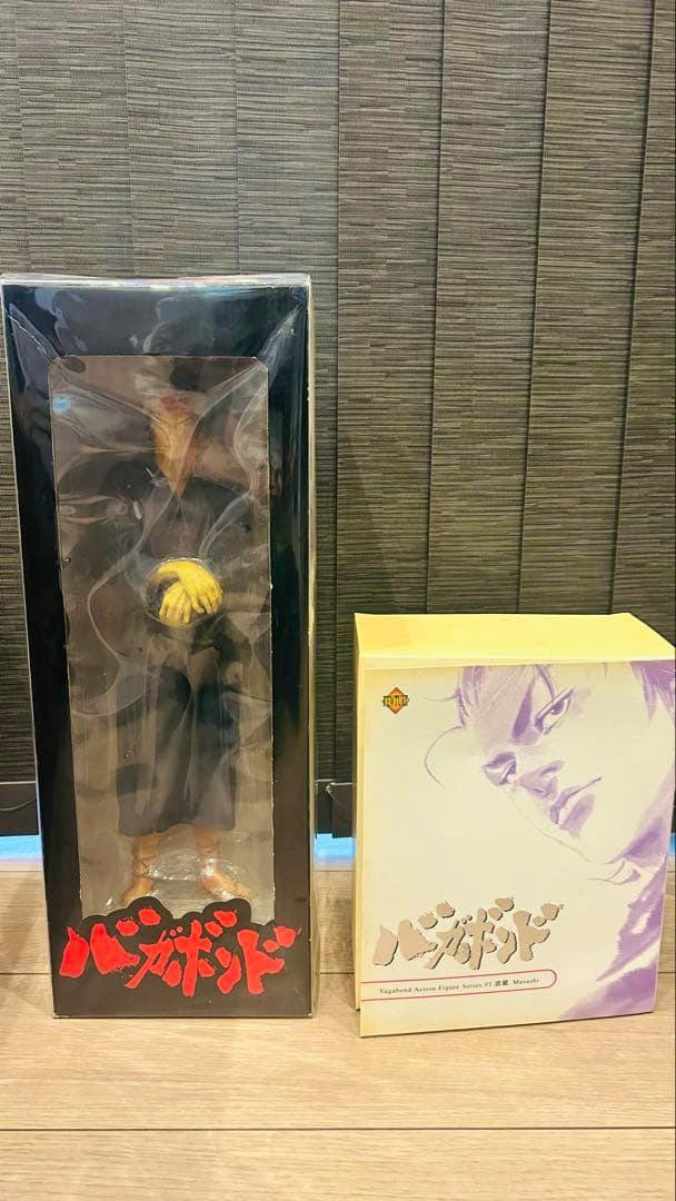 Two boxed Vagabond action figure packages shown side by side, one in a tall black window box and one in a shorter white illustrated box.