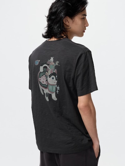 Back view of a man wearing a dark gray men's cotton shirt with a printed design on the back.