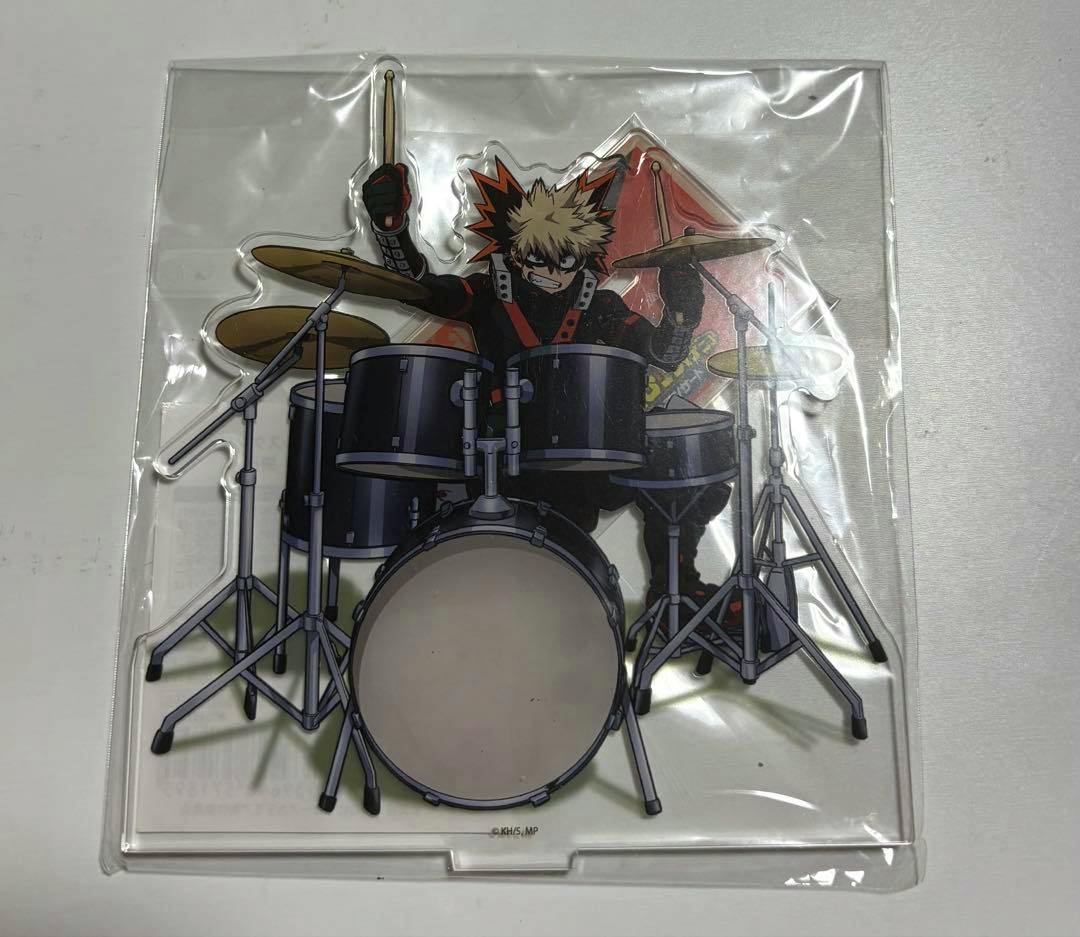 Acrylic decorative stand of Bakugo Katsuki (My Hero Academia) showing him behind a drum kit, sealed in clear plastic.