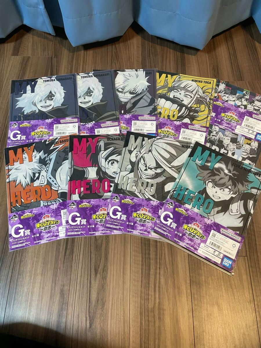 Photo of an assortment of Ichiban Kuji "My Hero Academia" lower-tier prize items laid out on a wooden floor.