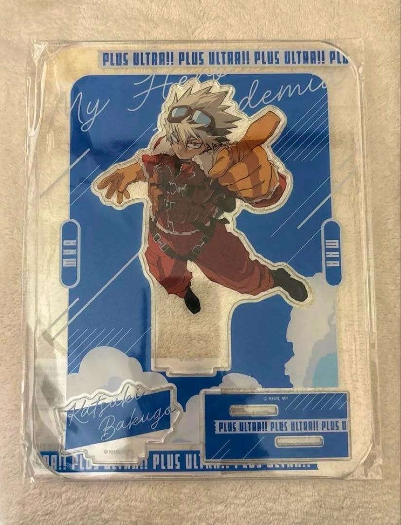 Front-facing photo of the packaged 僕のヒーローアカデミア アクリルスタンド JF2026Ver. 爆豪勝己 showing the acrylic character piece on a blue backing insert.