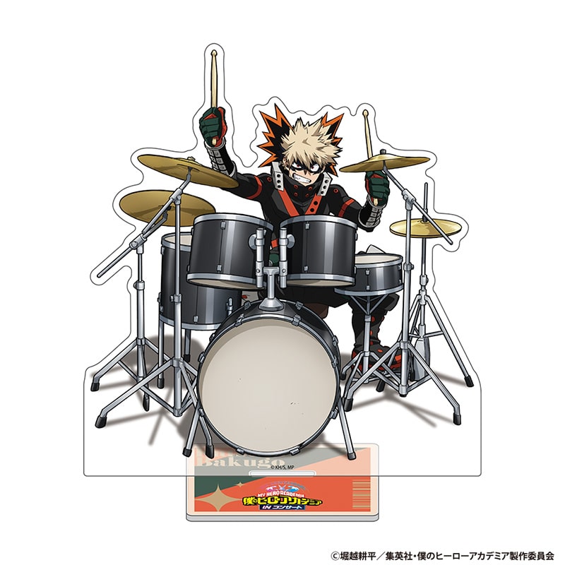 Acrylic stand of Bakugo Katsuki from My Hero Academia depicted playing a drum set, shown with its display base.