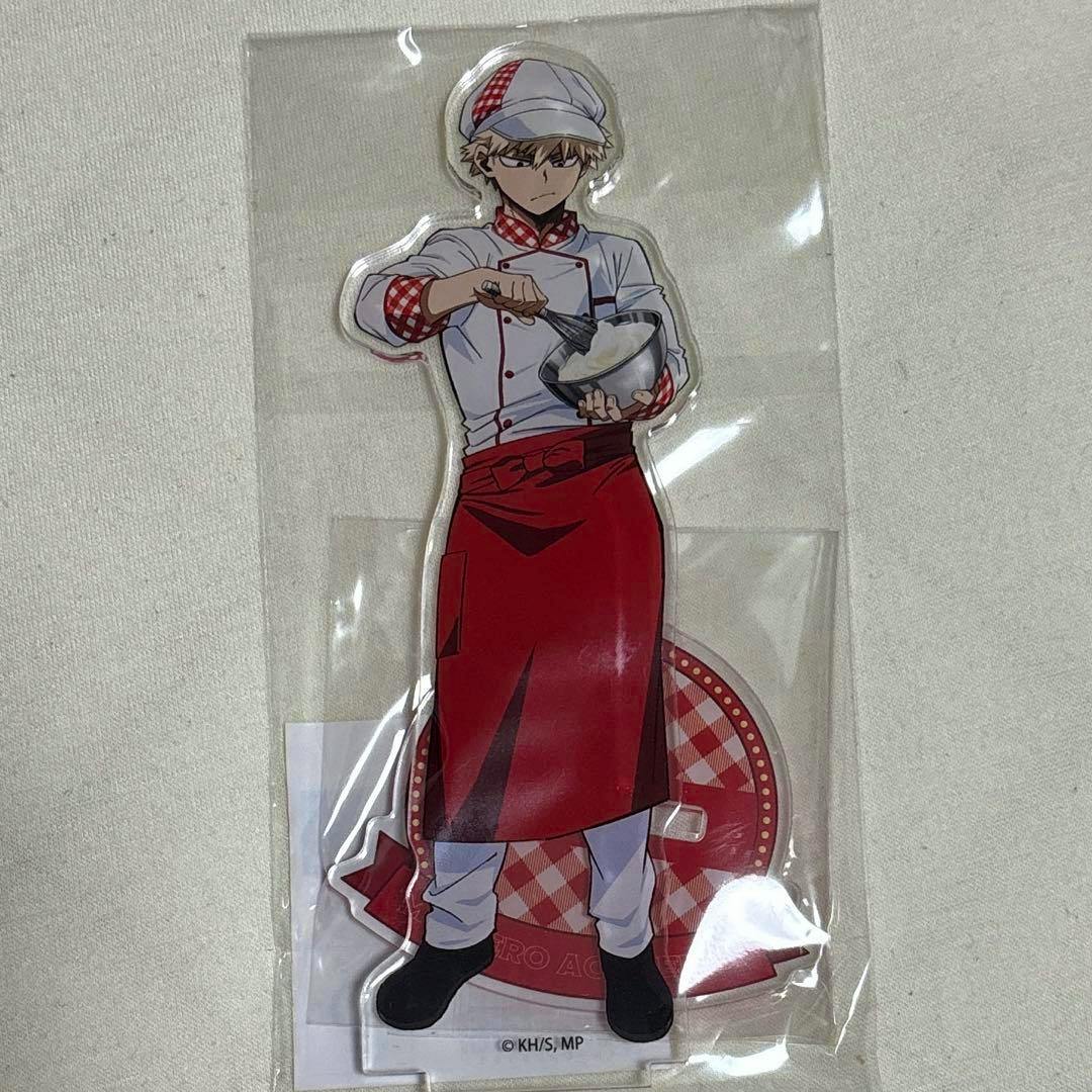 Acrylic stand of Bakugo from My Hero Academia wearing a chef uniform and red apron, packaged in clear plastic.