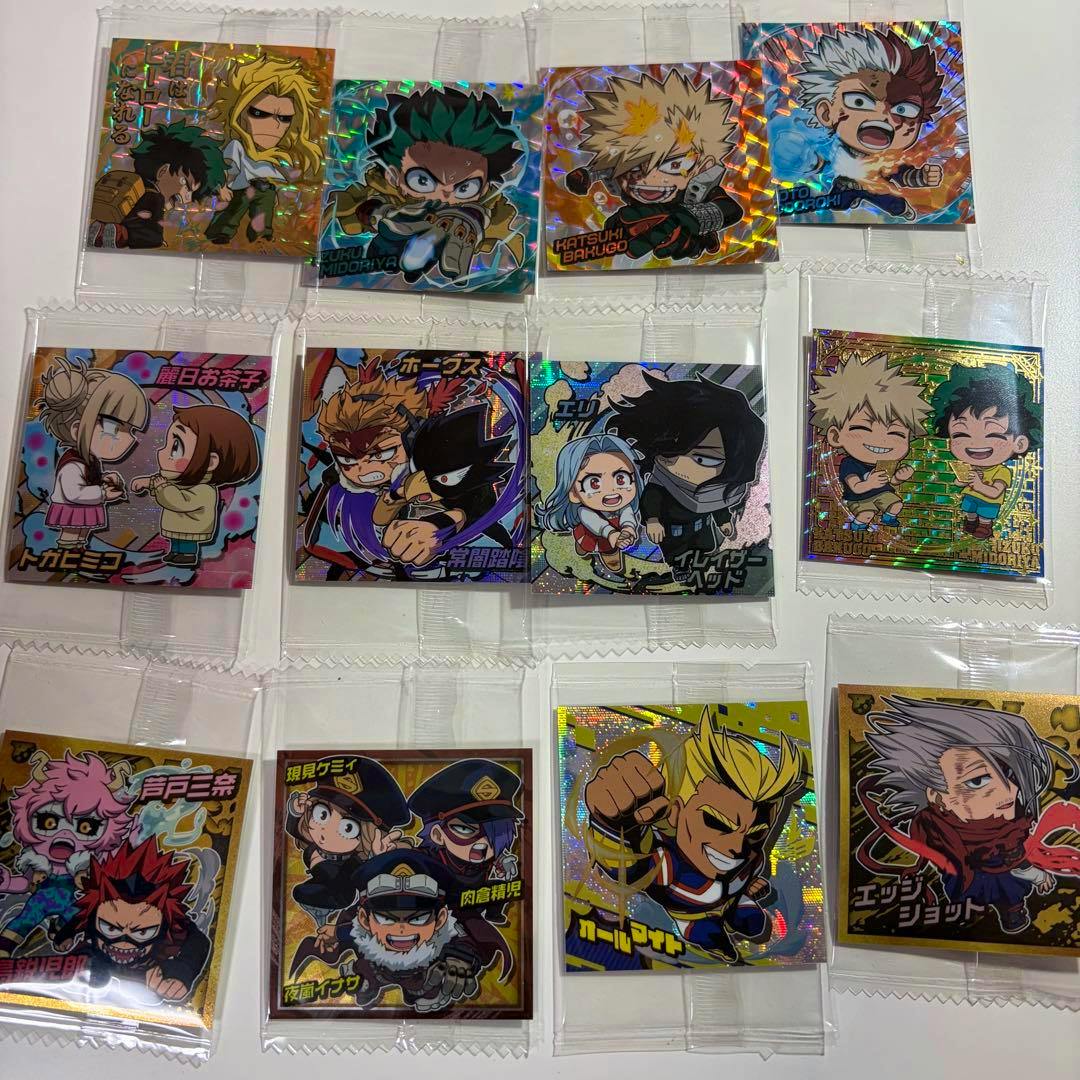 Multiple chibi-style My Hero Academia character stickers in individual clear plastic sleeves arranged on a white surface.