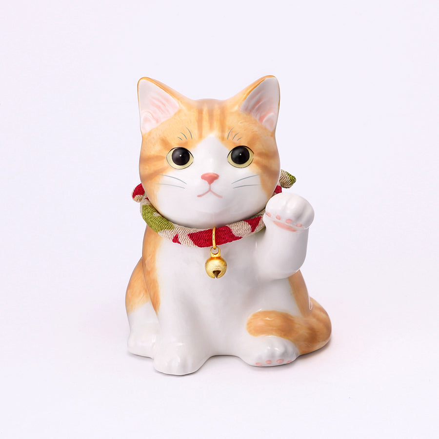 Ceramic figure of a sitting orange-and-white beckoning cat wearing a red-and-green collar with a bell.