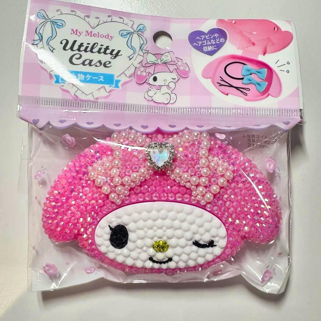 Packaged front view of a pink My Melody small plastic utility case decorated with beads and pearl-like embellishments.