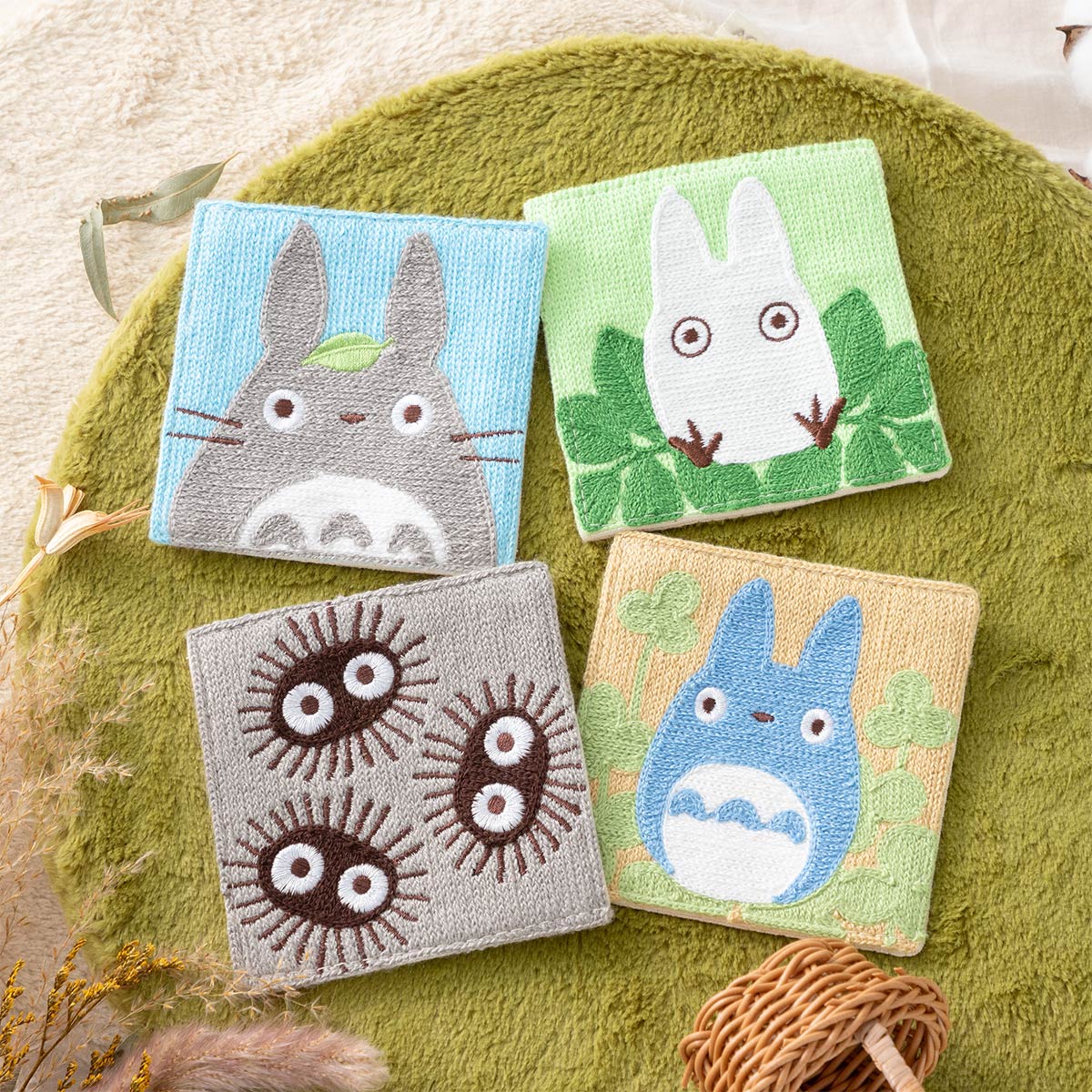 Four square Totoro-themed chain-stitch woven coasters (set of 4) arranged on a green round mat.