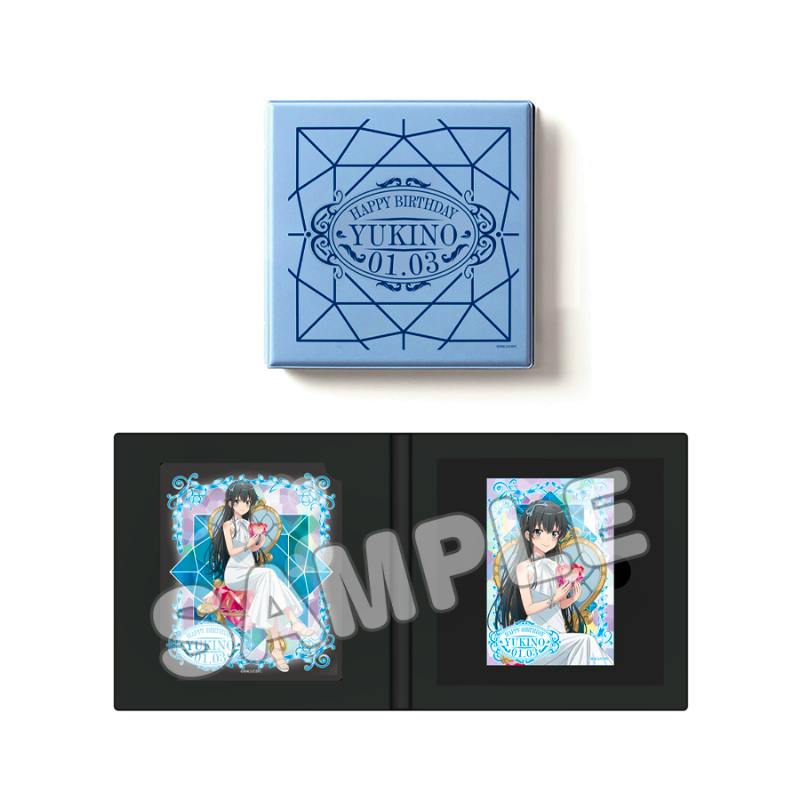 A blue square box above an open black case showing two illustrated badges featuring the character Yukino from the set.