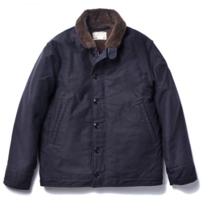 Front view of a navy N-1 deck jacket with a brown faux-fur collar laid flat on a white background.