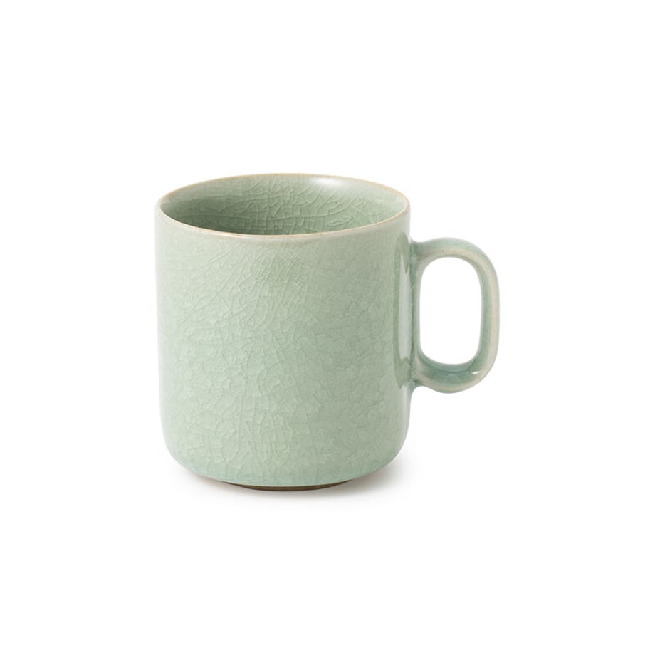 Light green ceramic mug with crackle glaze and a handle on a white background.
