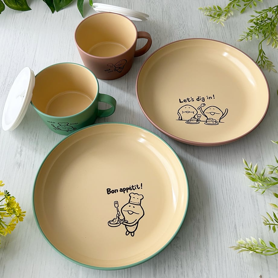 Two ceramic round plates and two soup cups (2-color set) with なめこ character illustrations arranged on a light surface.