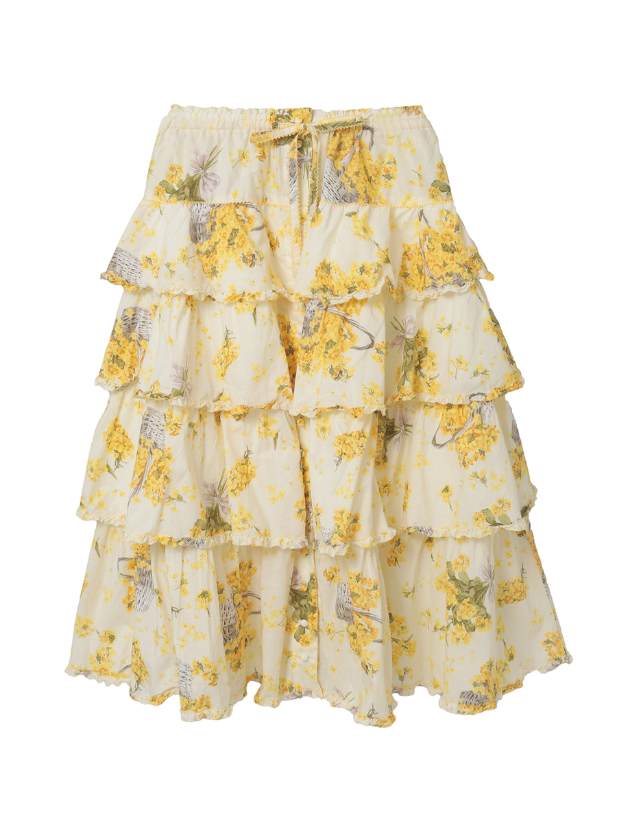 Front view of a women's cotton tiered skirt with a yellow floral print on a light background.