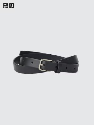 Narrow long black leather belt with a metal buckle coiled on a light background.
