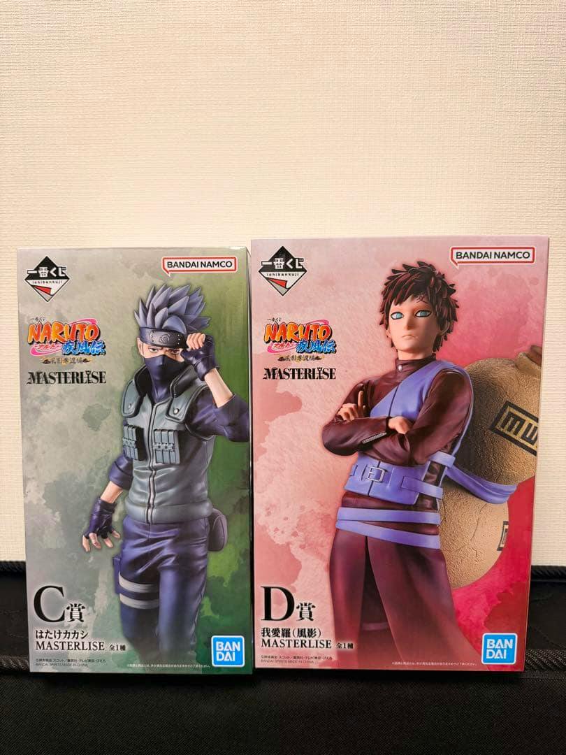 Boxed NARUTO Ichiban Kuji figures displayed side by side: C賞 はたけカカシ (left) and D賞 我愛羅 (right).