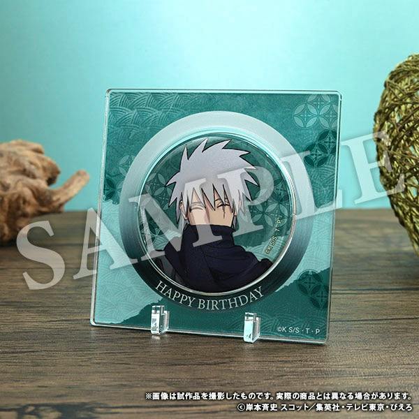 Square acrylic display stand holding a round Hatake Kakashi can badge that reads "HAPPY BIRTHDAY".