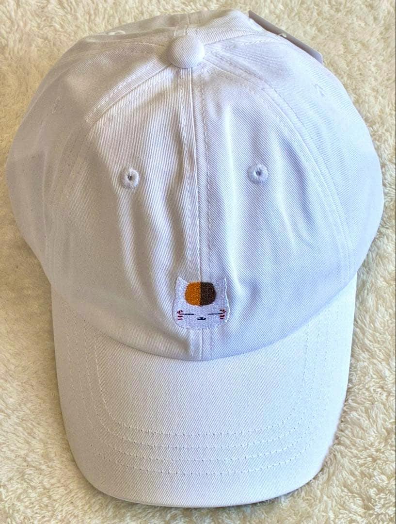 White cotton cap with a small embroidered cat face from Natsume's Book of Friends on the front.