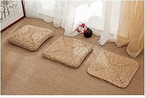 Three square zabuton cushions on a floor near a window.
