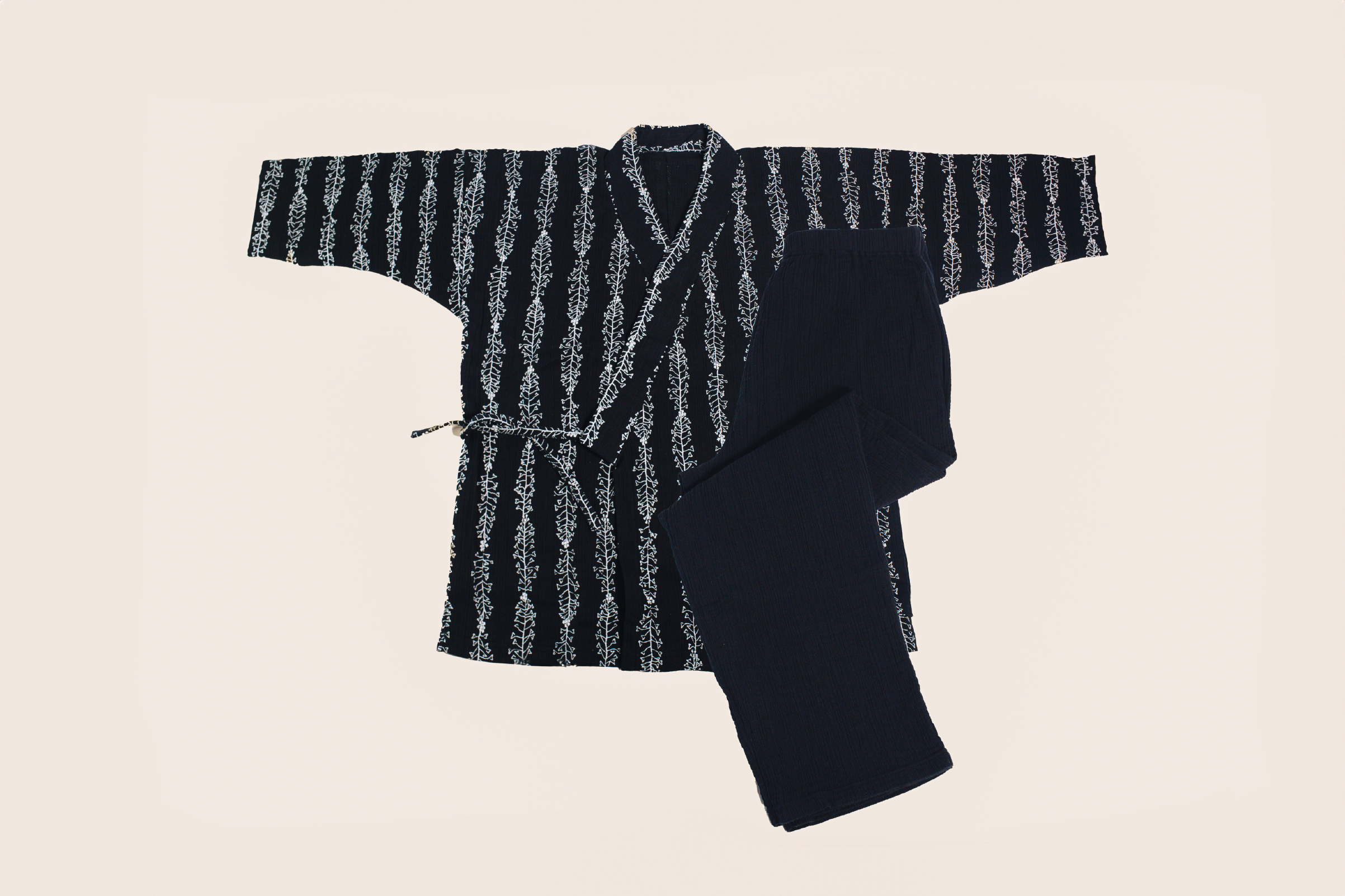 Flat lay of a dark patterned relaxing-wear sweater and matching pants.