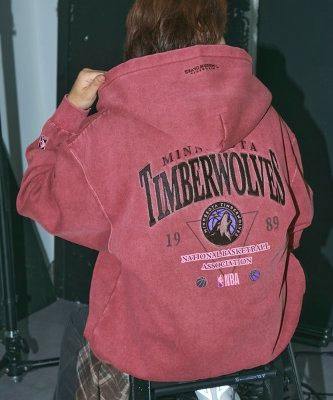 Back view of a model wearing the NBA Timberwolves pigment-processed oversized zip hoodie showing the embroidered team logo and back graphics.