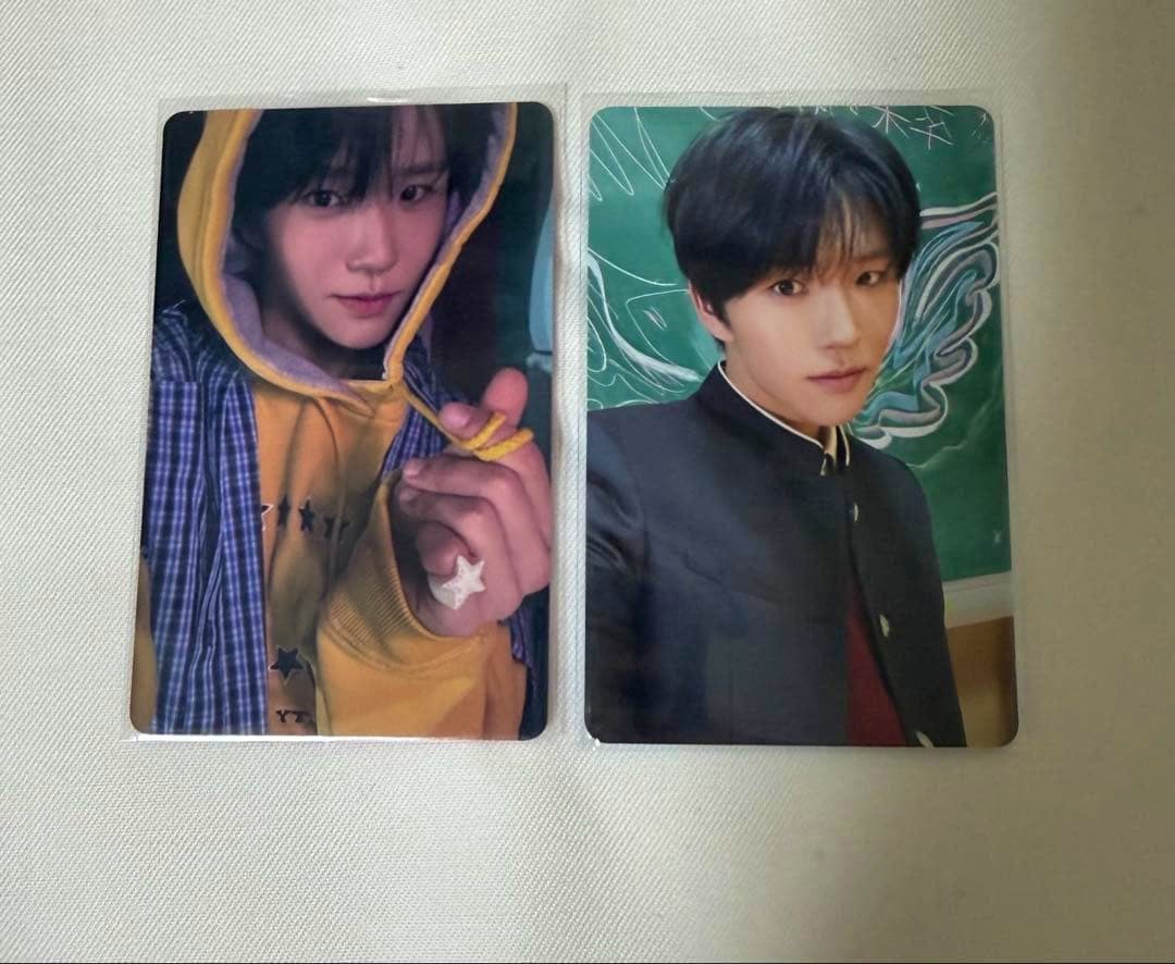 Two NCT WISH photocard portraits placed side by side on a light-colored surface.