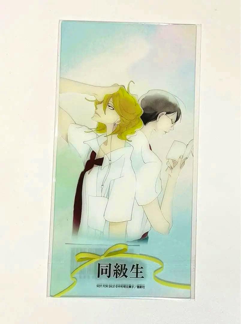 Close-up photo of the special sleeve (hologram card) showing two illustrated classmates back-to-back.