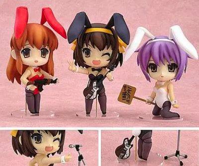 Three nendoroid figures of Haruhi, Mikuru, and Nagato in bunny outfits posed on a pink background.
