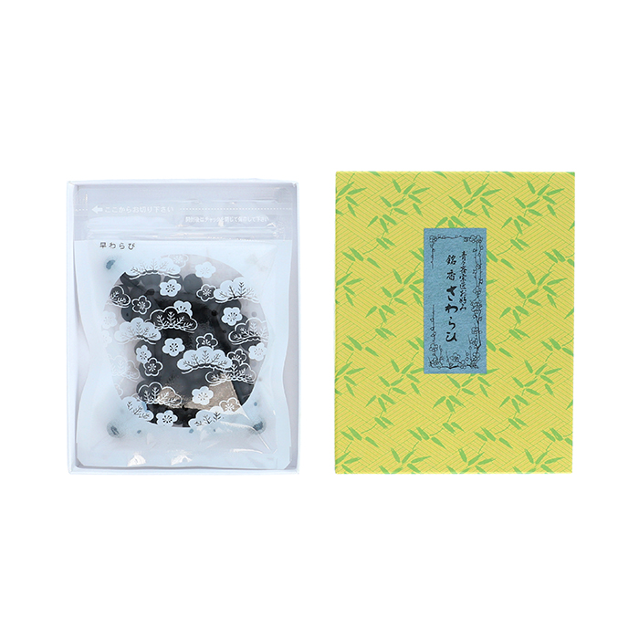 Packaging for the incense showing a clear pouch with dark pellets next to a yellow patterned box.