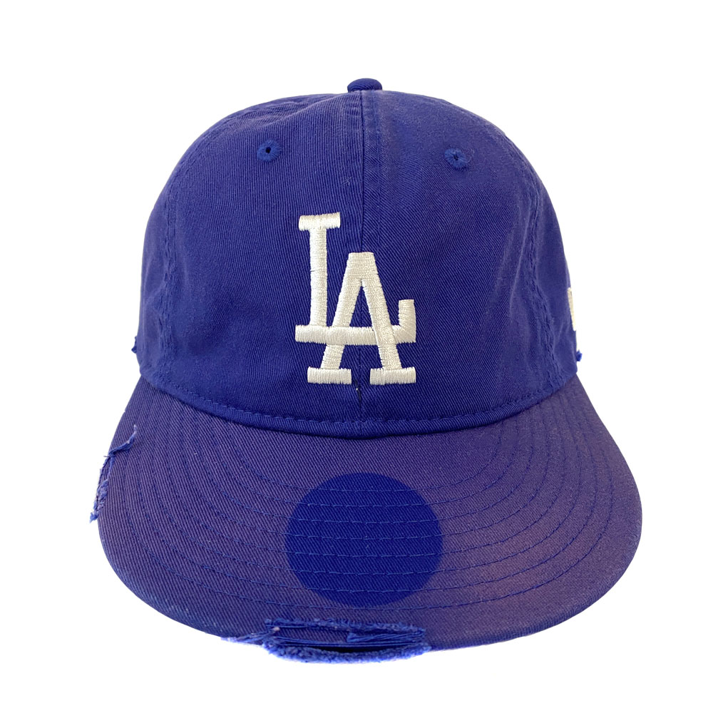 Front view of a blue Los Angeles Dodgers New Era baseball cap with a white "LA" logo and a distressed brim.