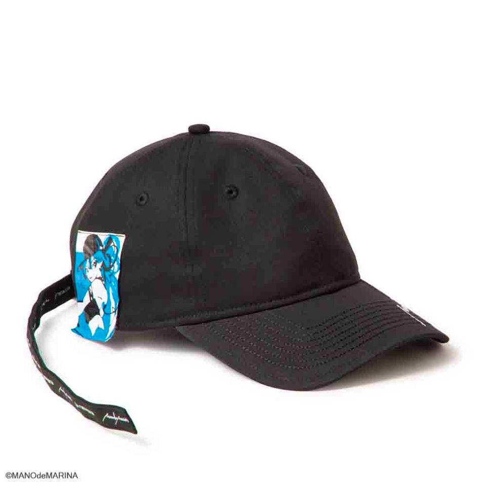 A black 9TWENTY cotton baseball cap with a long strap and an attached blue illustration tag.