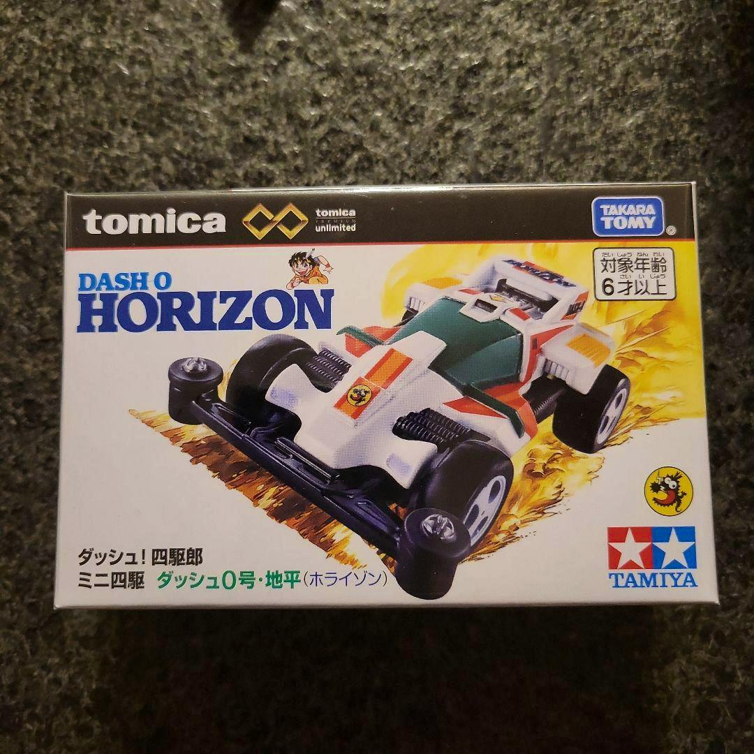 Boxed Tomica Premium Dash 0 Horizon toy showing the front of the product packaging with car artwork and brand logos.