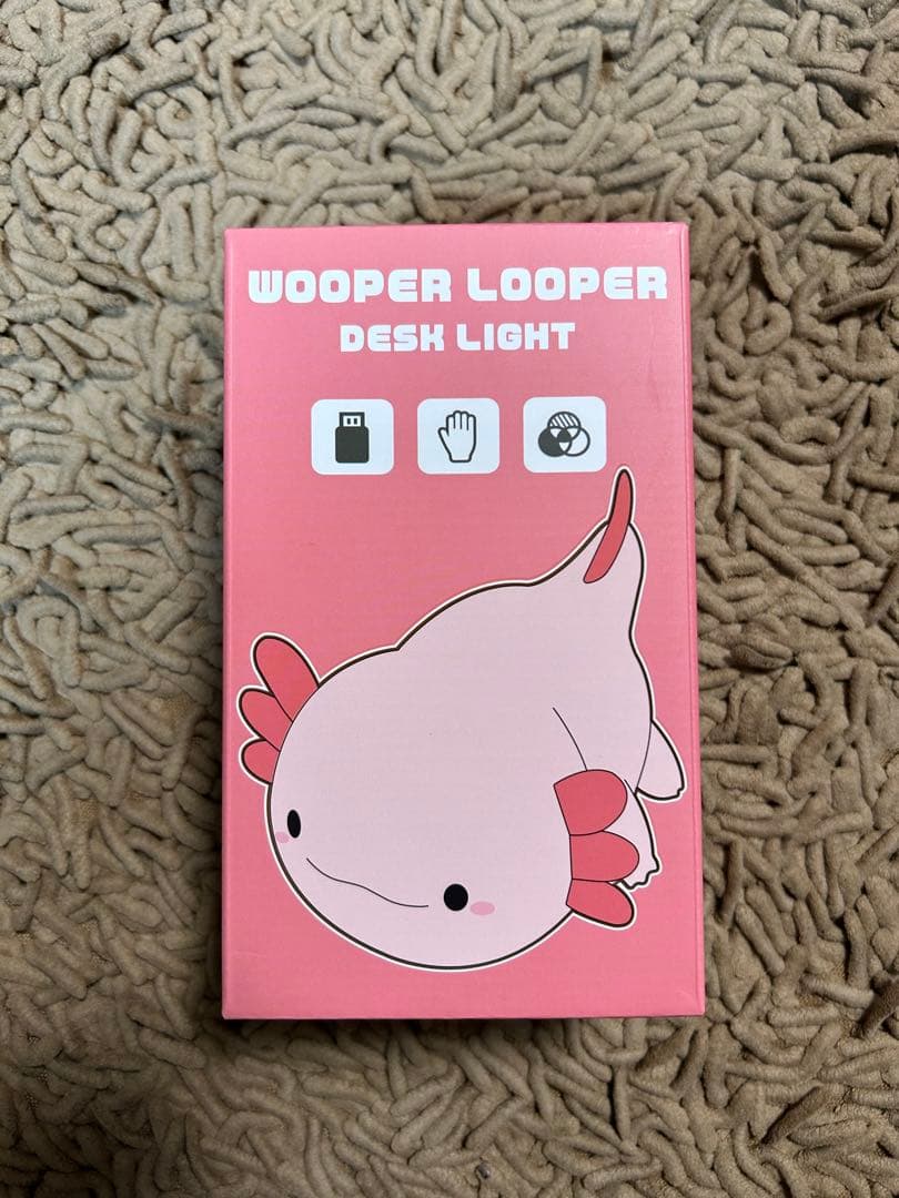 Retail box for a Wooper Looper desk light showing a pink axolotl illustration.