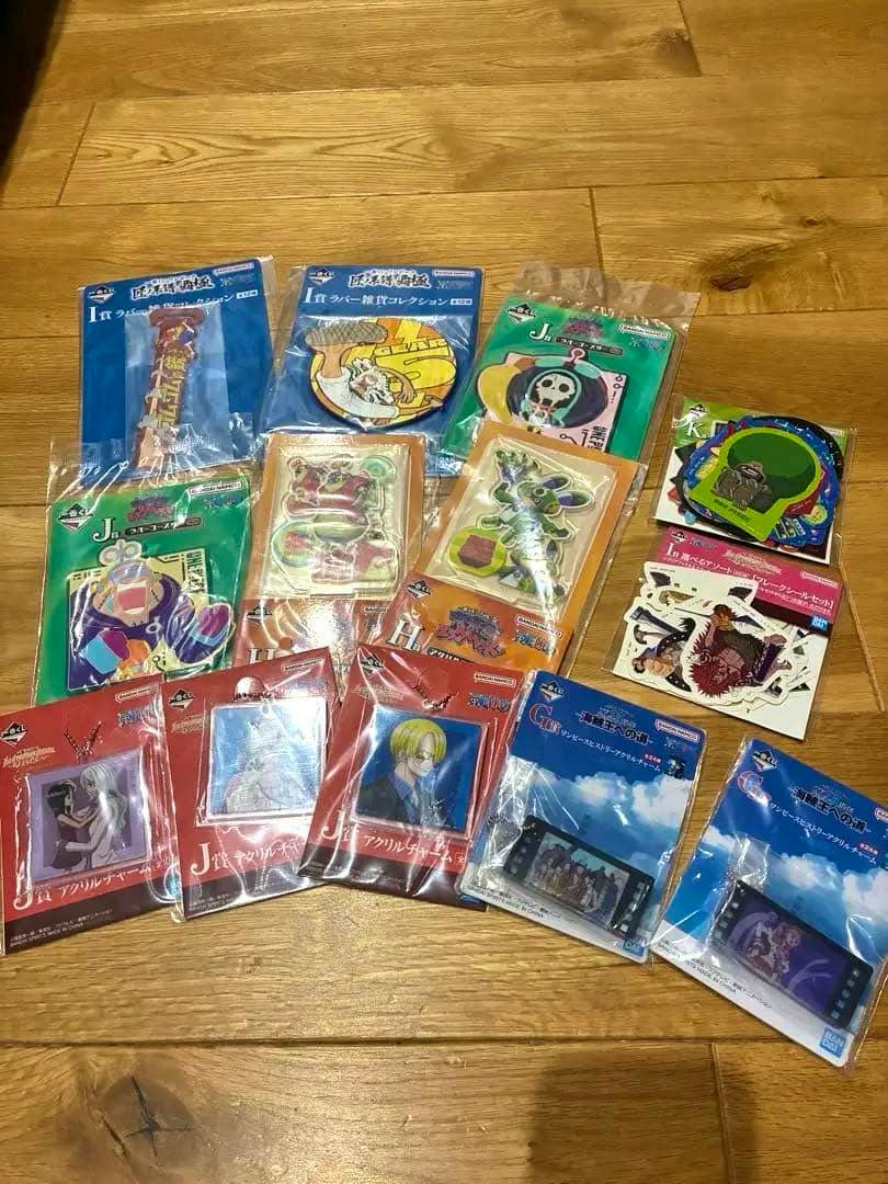 Photo of multiple unopened Ichiban Kuji One Piece goods in their packaging arranged on a wooden floor.