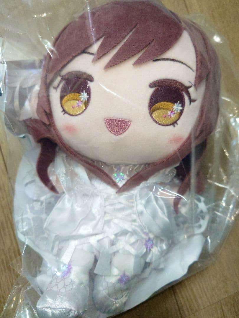 Full-length photo of the Amana Ōsaki "Mochi What!" plush toy sealed in clear plastic packaging.