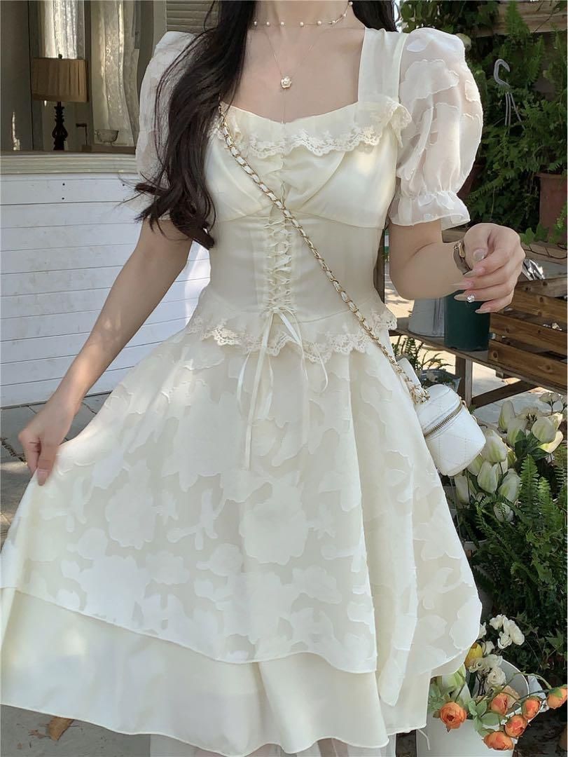 Model wearing the white women's party dress with puff sleeves and a layered skirt.
