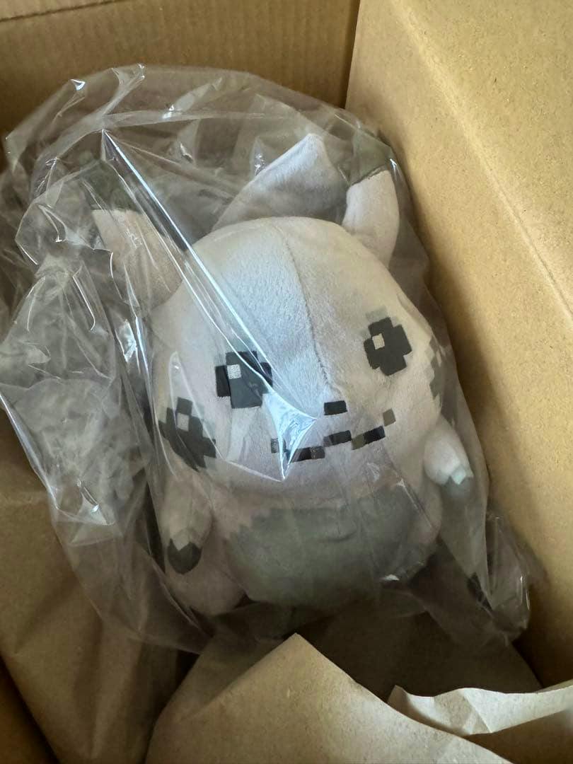 A 30th anniversary Pikachu plush wrapped in clear plastic and placed inside a cardboard box.