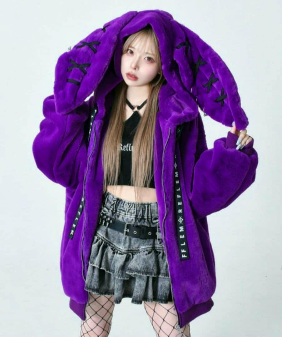 A model wearing a purple rabbit-eared hooded faux-fur parka shown from the front.