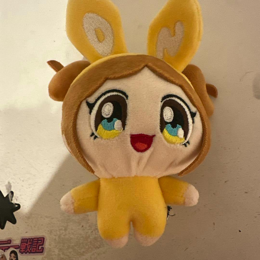 Front view of the Daniel plush keyring showing its embroidered face, yellow outfit, and ears.