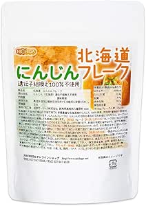 Front view of a white resealable pouch of NICHIGA Hokkaido carrot flakes with Japanese text and a nutrition label visible.
