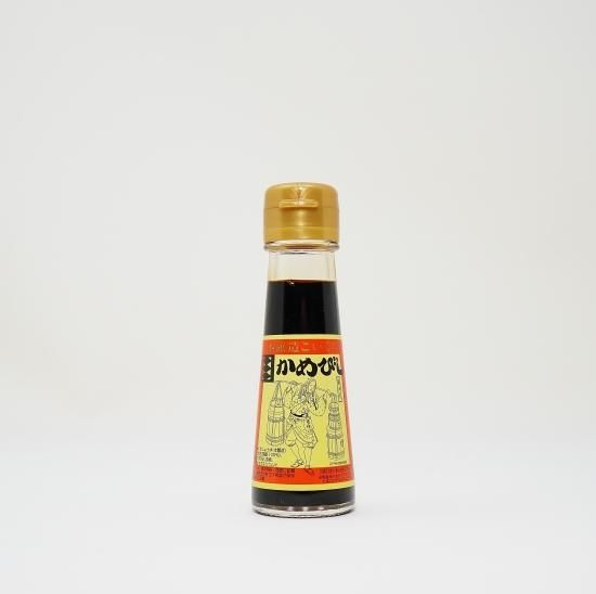A bottle of soy sauce with a yellow label and a gold cap on a white background.