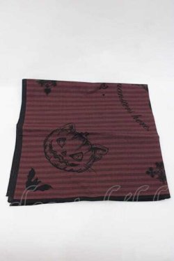 Folded red-striped cotton handkerchief with printed pumpkin and floral motifs on a white background.