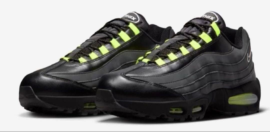 Pair of Nike Air Max 95 Big Bubble SE black shoes with volt accents shown on a white background.