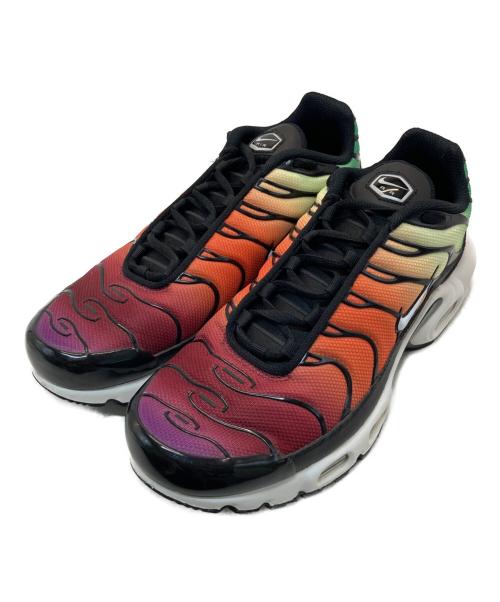 Pair of Air Max Plus sneakers with a red-to-yellow gradient textile upper, black laces, and white midsoles.