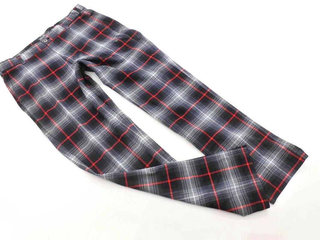 Flat-lay photo of Nike check-pattern golf pants in gray, black, and red on a white background.