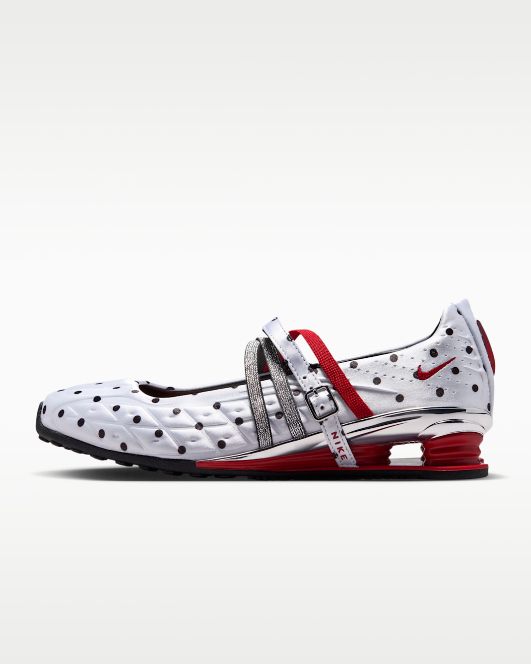 Side view of a Nike Shox Z Calistra SP sports shoe in white with black polka dots, silver straps, and red Shox columns.