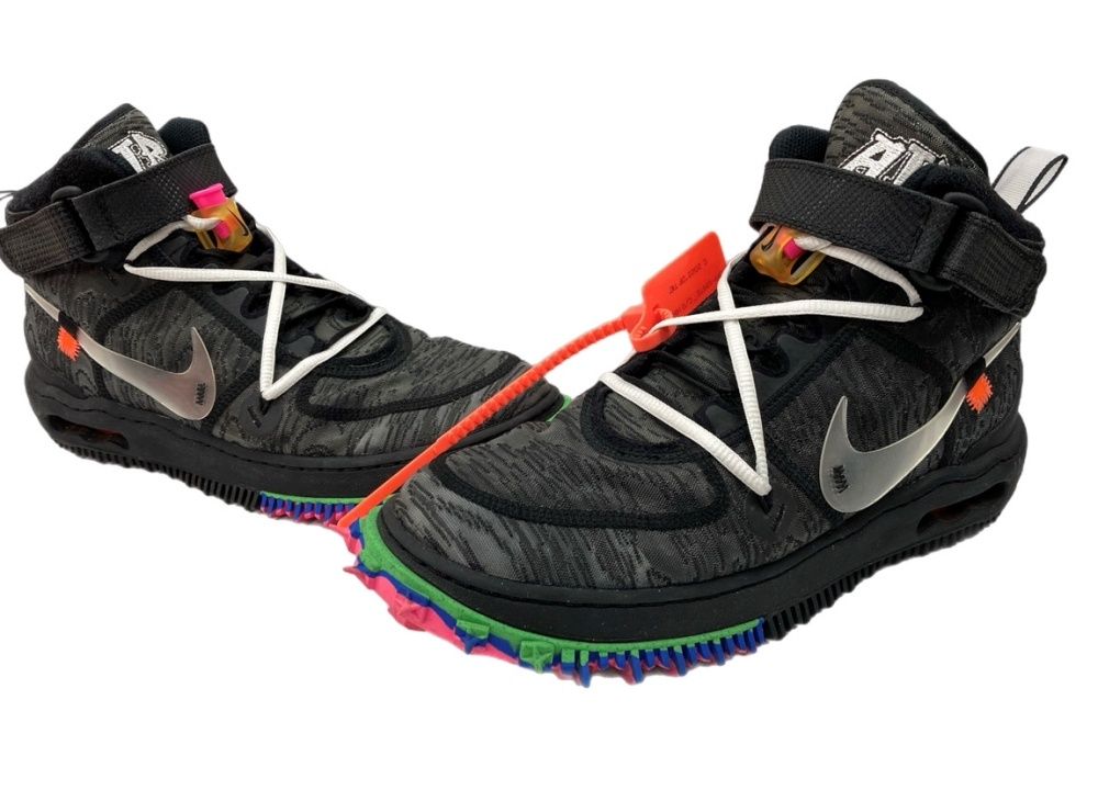 Black Nike × Off-White Air Force 1 Mid sneakers with multicolored outsole and orange zip tie shown on a white background.